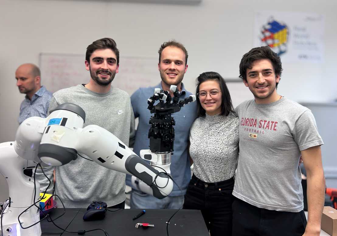 Group photo of Matteo Leonforte with his team colleagues and the robotic hand they developed
